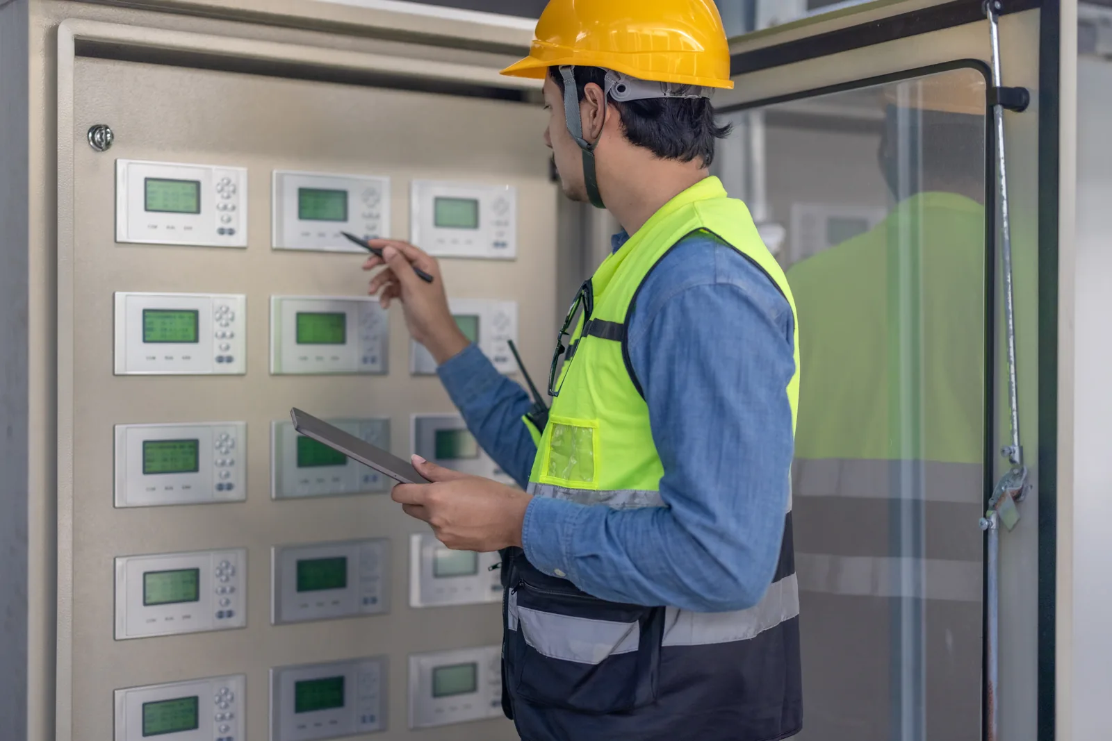 Technician checking control panel displays